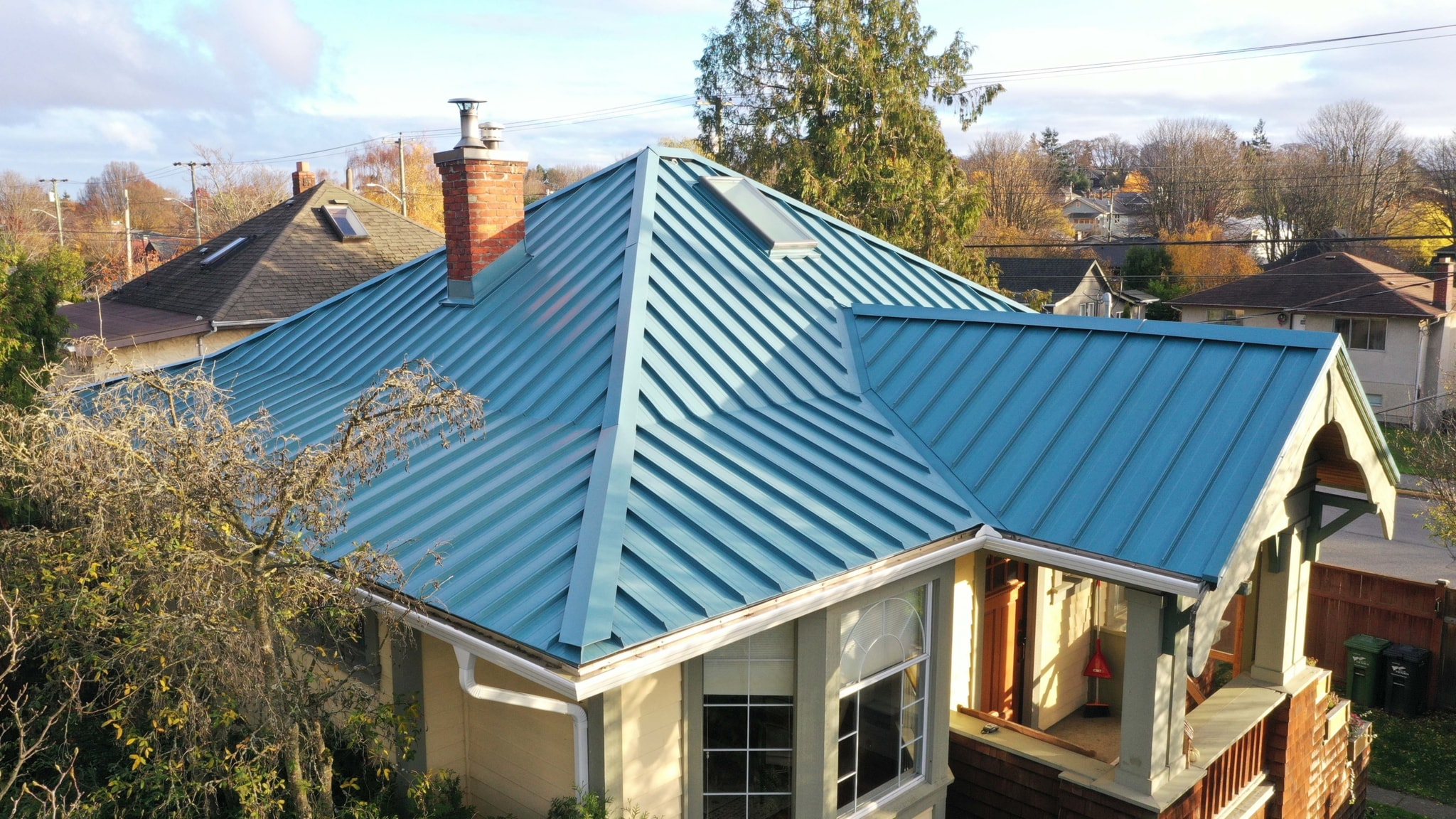 Blue pinch seam metal roof on the Avebury home